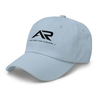 Gorra clásica azul claro con logo AR y frase 'We Are The Vision' en la parte frontal