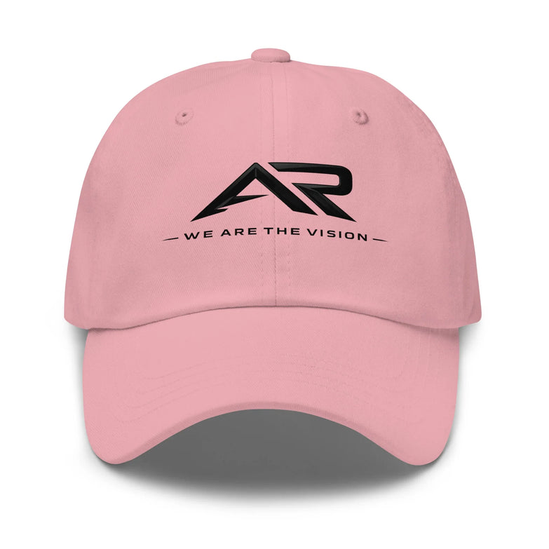 Gorra rosa tipo dad hat con logo AR negro y texto 'We Are The Vision' en el frente