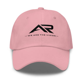 Gorra rosa tipo dad hat con logo AR negro y texto 'We Are The Vision' en el frente