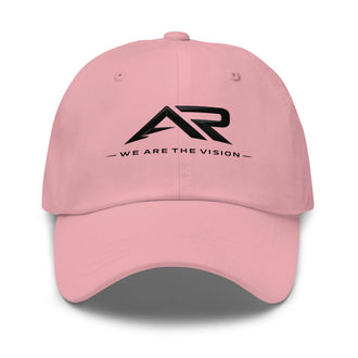 Gorra rosa tipo dad hat con logo AR negro y texto 'We Are The Vision' en el frente